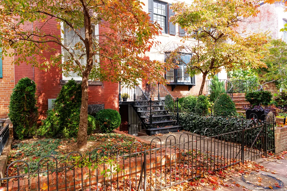 Brick row house with black iron railings, the kind of rental investors look at in Weldon Spring, Missouri